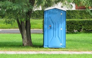 porta potty under a tree